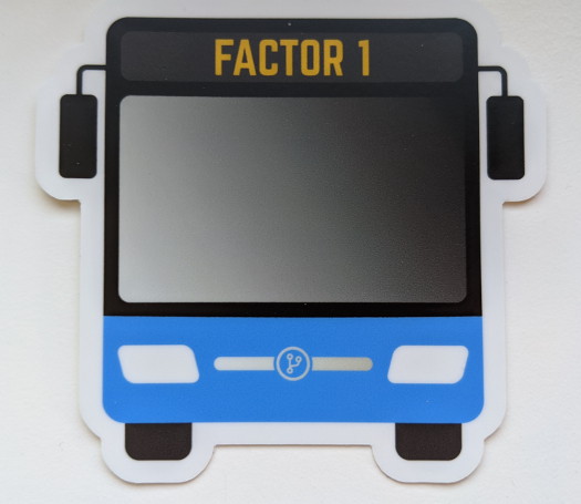 A bus-shaped sticker with the text 'Factor 1' near the top, and a blue accent color