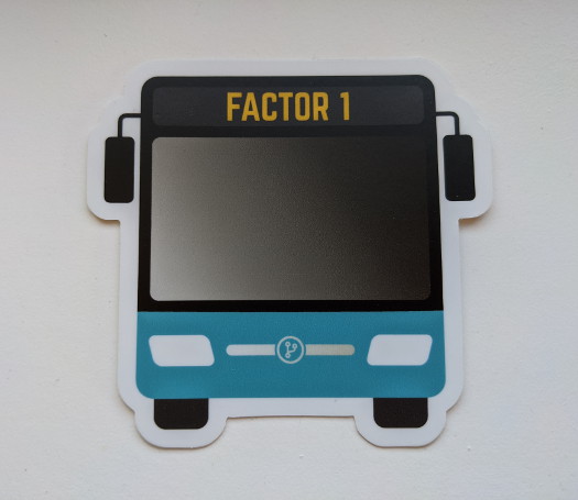A bus-shaped sticker with the text 'Factor 1' near the top, and a cyan accent color