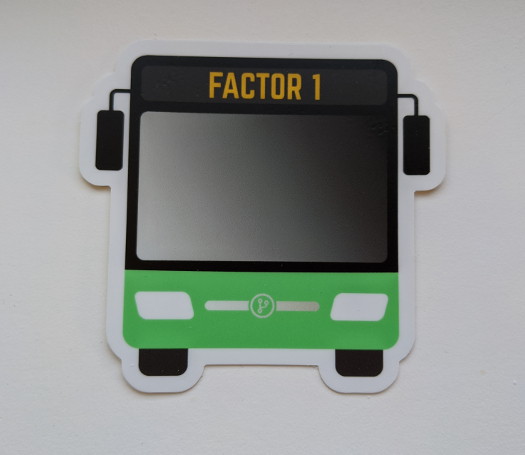 A bus-shaped sticker with the text 'Factor 1' near the top, and a light green accent color