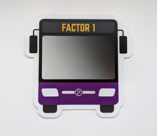 A bus-shaped sticker with the text 'Factor 1' near the top, and a purple accent color