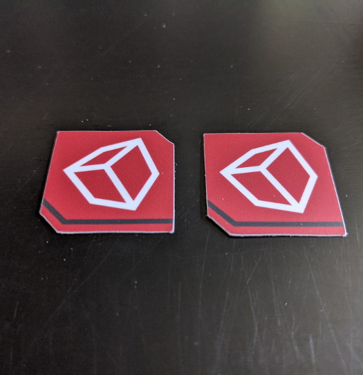 Two small square stickers with cubes on them